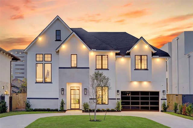 view of front of home with a yard and a garage