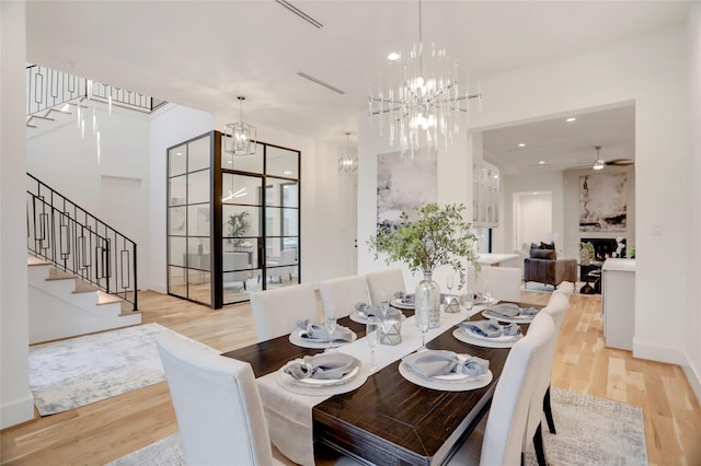 dining space with light hardwood / wood-style floors and ceiling fan