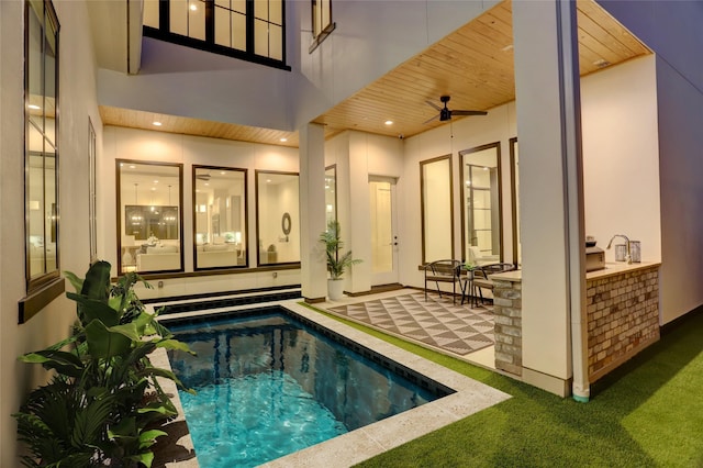 view of swimming pool with a patio and ceiling fan