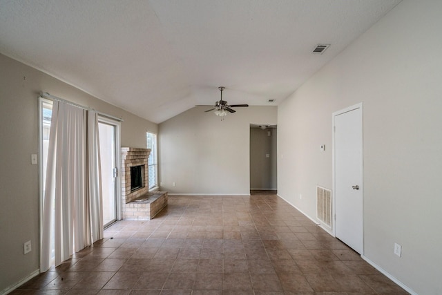 unfurnished living room featuring a fireplace, plenty of natural light, lofted ceiling, and ceiling fan