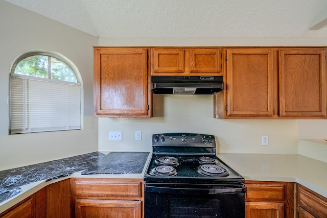 kitchen with black range with electric stovetop and a textured ceiling