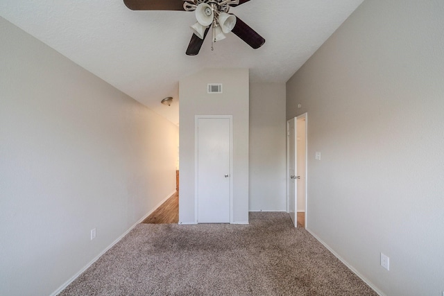 unfurnished bedroom featuring carpet, ceiling fan, and lofted ceiling