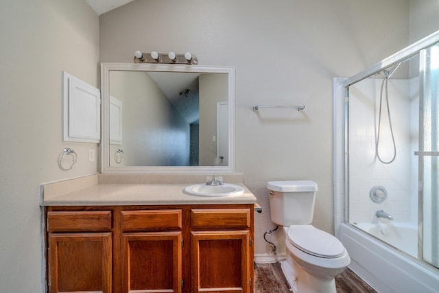 full bathroom featuring vanity, hardwood / wood-style flooring, enclosed tub / shower combo, toilet, and lofted ceiling