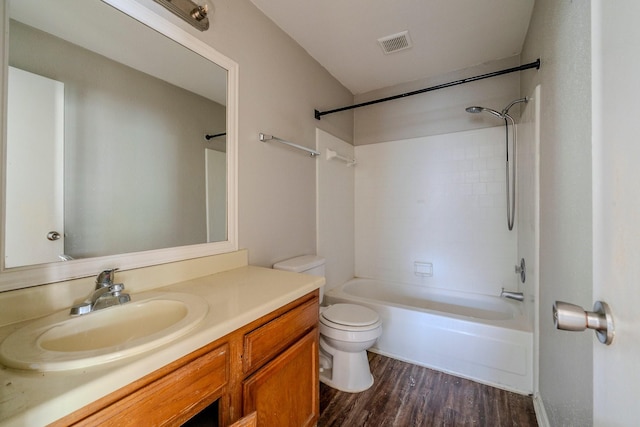 full bathroom featuring hardwood / wood-style floors, vanity, toilet, and shower / tub combination