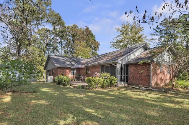 back of house with a patio and a lawn