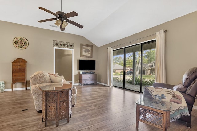 living room featuring ceiling fan, lofted ceiling, and hardwood / wood-style flooring