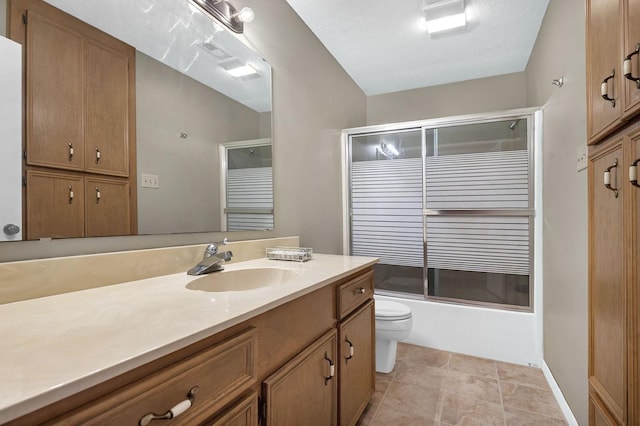 full bathroom with vanity, enclosed tub / shower combo, a textured ceiling, and toilet