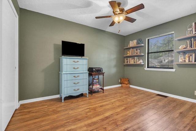 misc room with ceiling fan and light hardwood / wood-style flooring