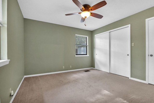 unfurnished bedroom featuring ceiling fan, carpet floors, and a closet