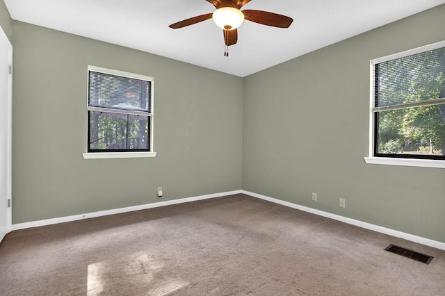 carpeted empty room featuring ceiling fan