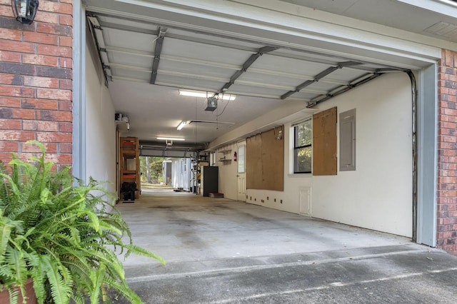 garage with electric panel and a garage door opener