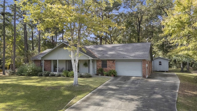 ranch-style home with a front yard, a porch, a garage, and a storage unit