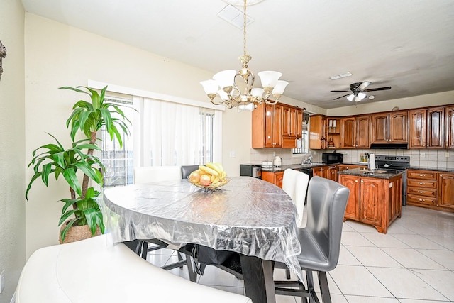 interior space with ceiling fan with notable chandelier and light tile patterned flooring