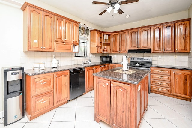 kitchen featuring a center island, black appliances, dark stone countertops, light tile patterned floors, and tasteful backsplash