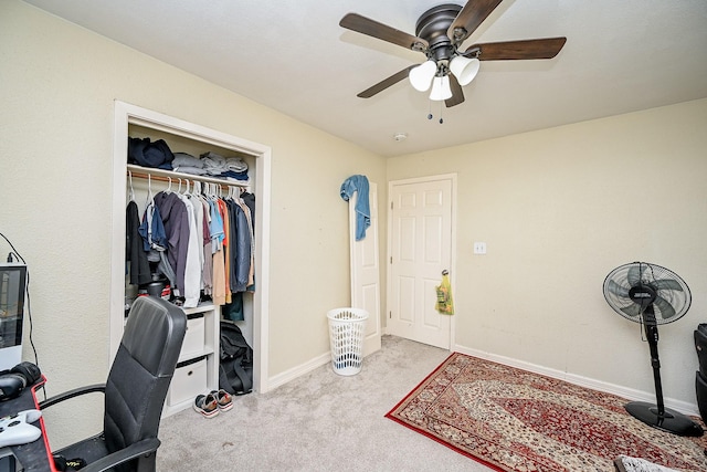 carpeted office space featuring ceiling fan