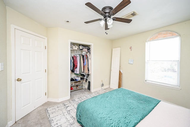 carpeted bedroom featuring a closet and ceiling fan