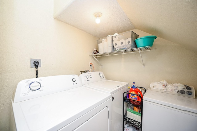 laundry room featuring a textured ceiling and washer and clothes dryer