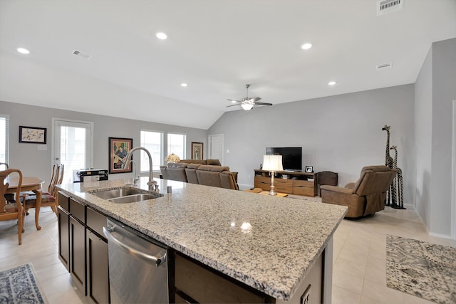 kitchen featuring a kitchen island with sink, sink, vaulted ceiling, stainless steel dishwasher, and ceiling fan