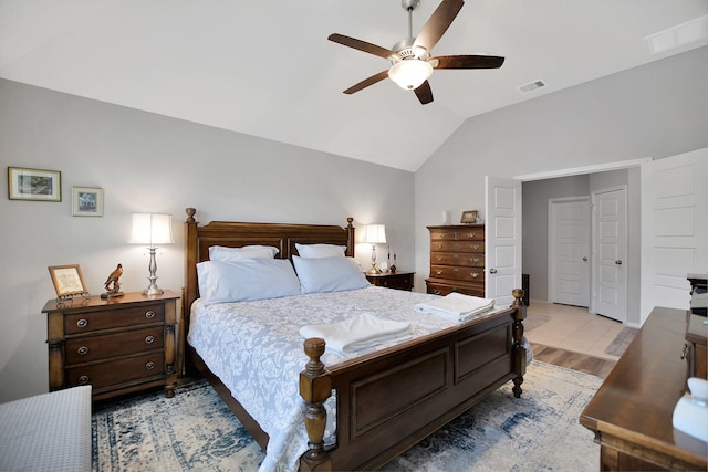 bedroom with light hardwood / wood-style flooring, vaulted ceiling, and ceiling fan