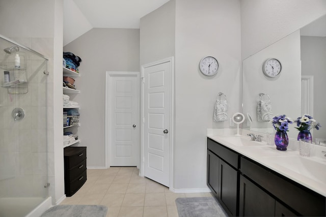 bathroom with tile patterned flooring, vanity, a shower with shower door, and lofted ceiling