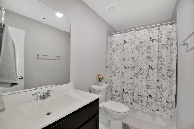 bathroom with tile patterned flooring, vanity, and toilet