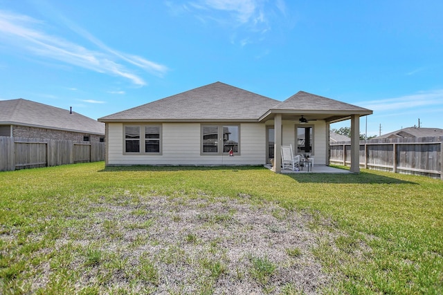 rear view of property featuring a patio, ceiling fan, and a lawn