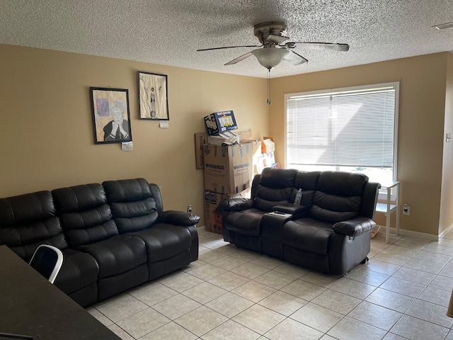 tiled living room featuring ceiling fan and a textured ceiling