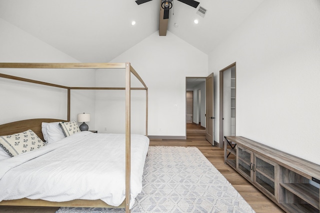 bedroom with beamed ceiling, hardwood / wood-style flooring, high vaulted ceiling, and ceiling fan