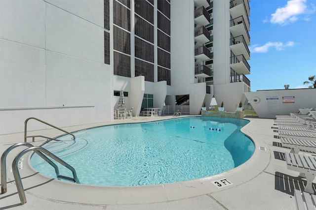 view of swimming pool featuring a patio area