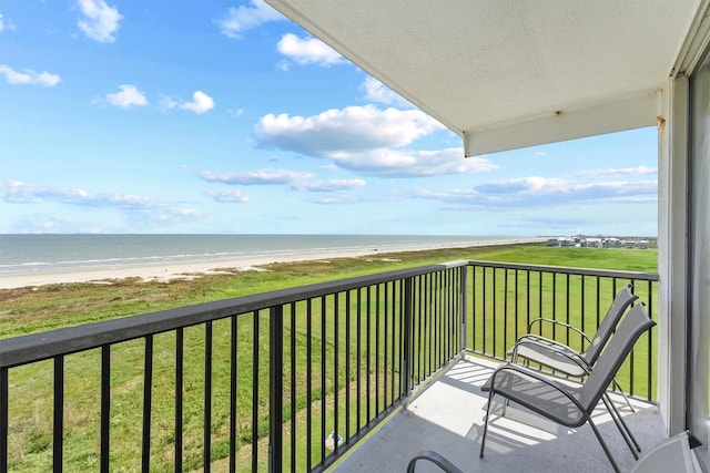 balcony with a beach view and a water view