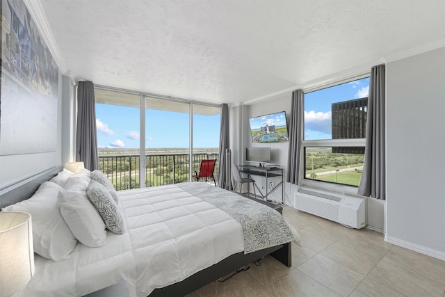 bedroom with light tile patterned floors, a textured ceiling, a wall of windows, and crown molding