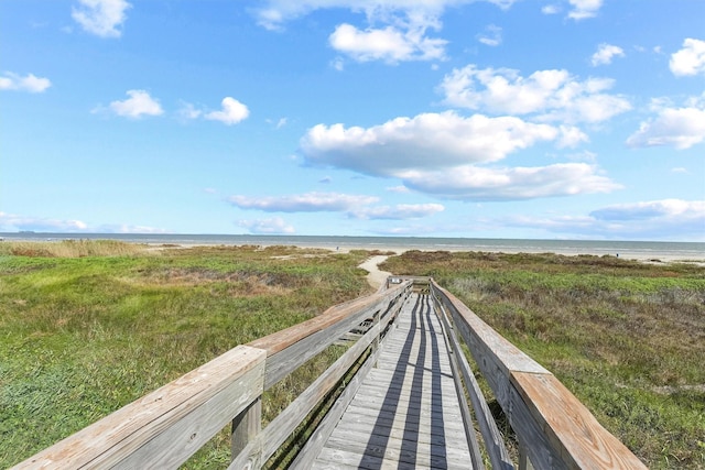 view of home's community featuring a water view and a view of the beach