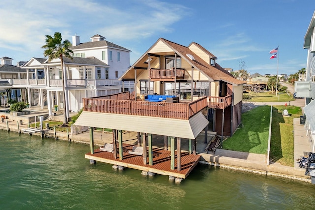 view of dock with a yard and a water view