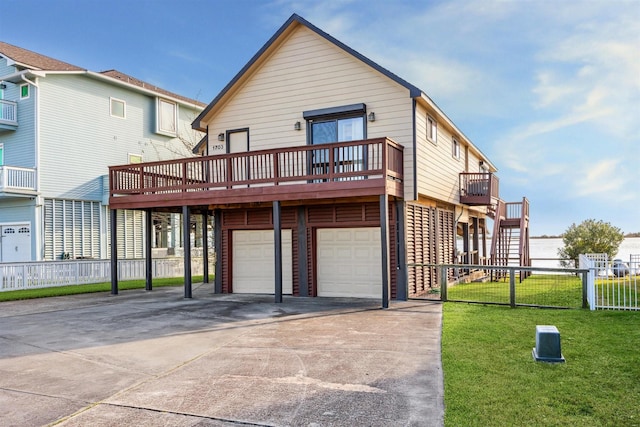 exterior space featuring a yard, a garage, and a wooden deck