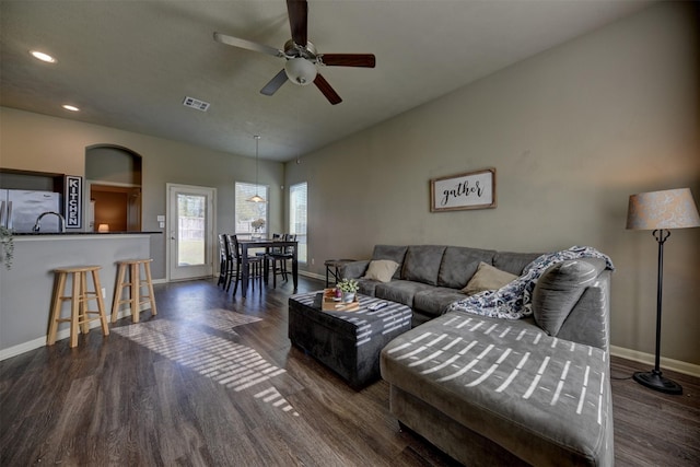 living room featuring dark hardwood / wood-style flooring and ceiling fan