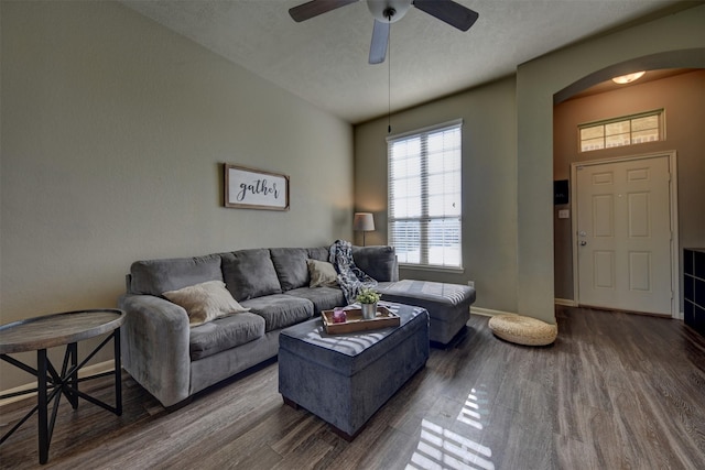 living room featuring wood-type flooring, a textured ceiling, and ceiling fan