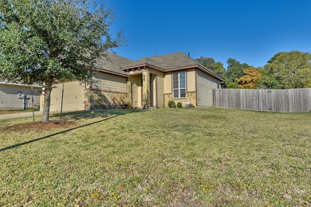 view of front of property with a garage and a front lawn