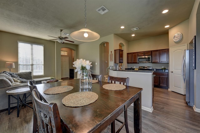 dining room featuring ceiling fan and dark wood-type flooring