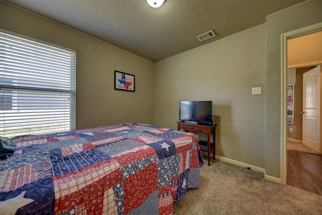 carpeted bedroom with a textured ceiling