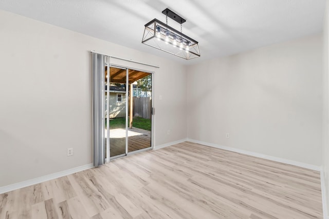 empty room with light hardwood / wood-style flooring