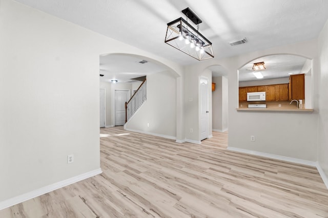 unfurnished living room with light wood-type flooring