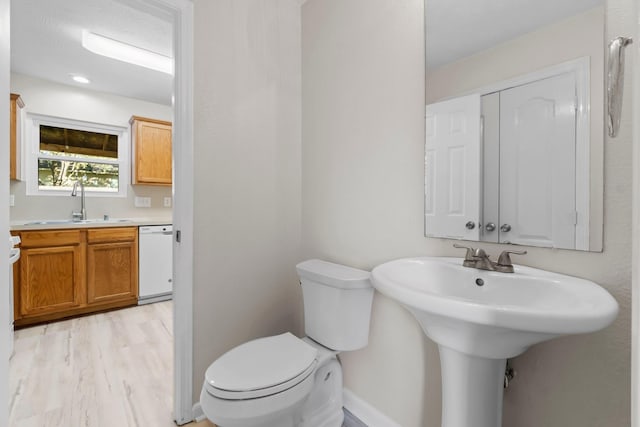 bathroom with sink, hardwood / wood-style floors, and toilet