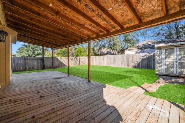 wooden deck with a yard and a storage shed