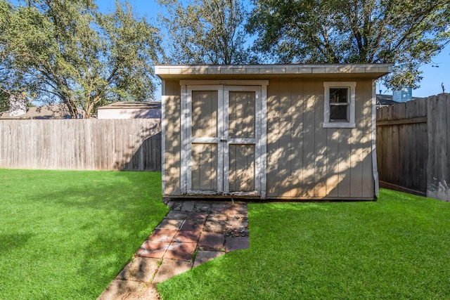 view of outbuilding featuring a lawn