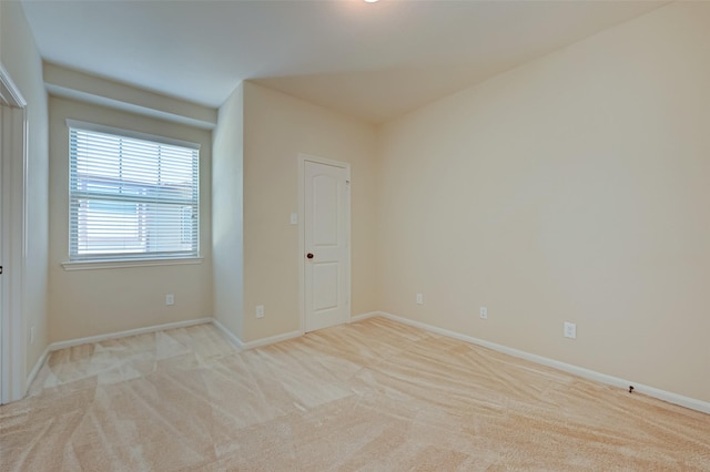 empty room featuring light colored carpet