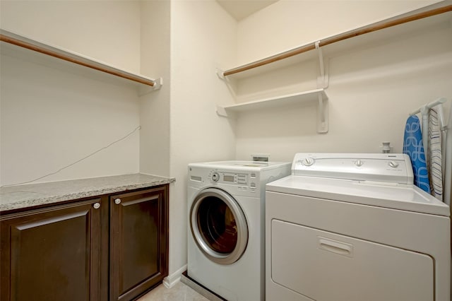 washroom featuring cabinets and washer and dryer