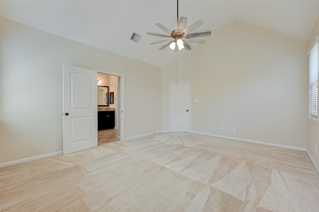 empty room with ceiling fan, light colored carpet, and lofted ceiling