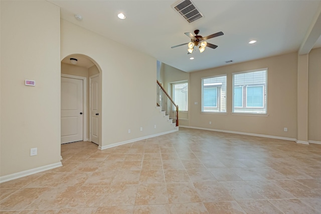 tiled empty room featuring ceiling fan