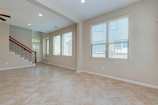 tiled empty room with ceiling fan