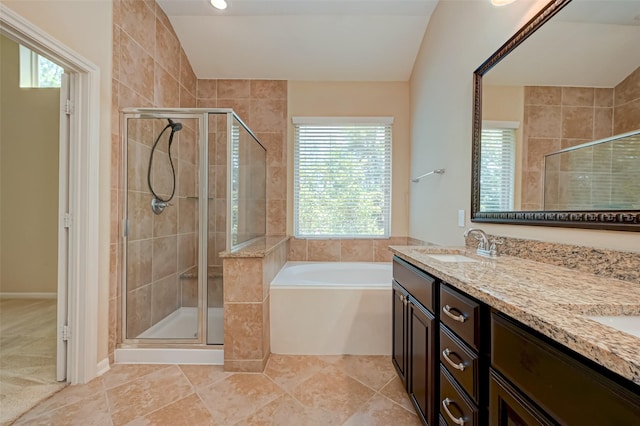 bathroom with lofted ceiling, vanity, tile patterned floors, and independent shower and bath